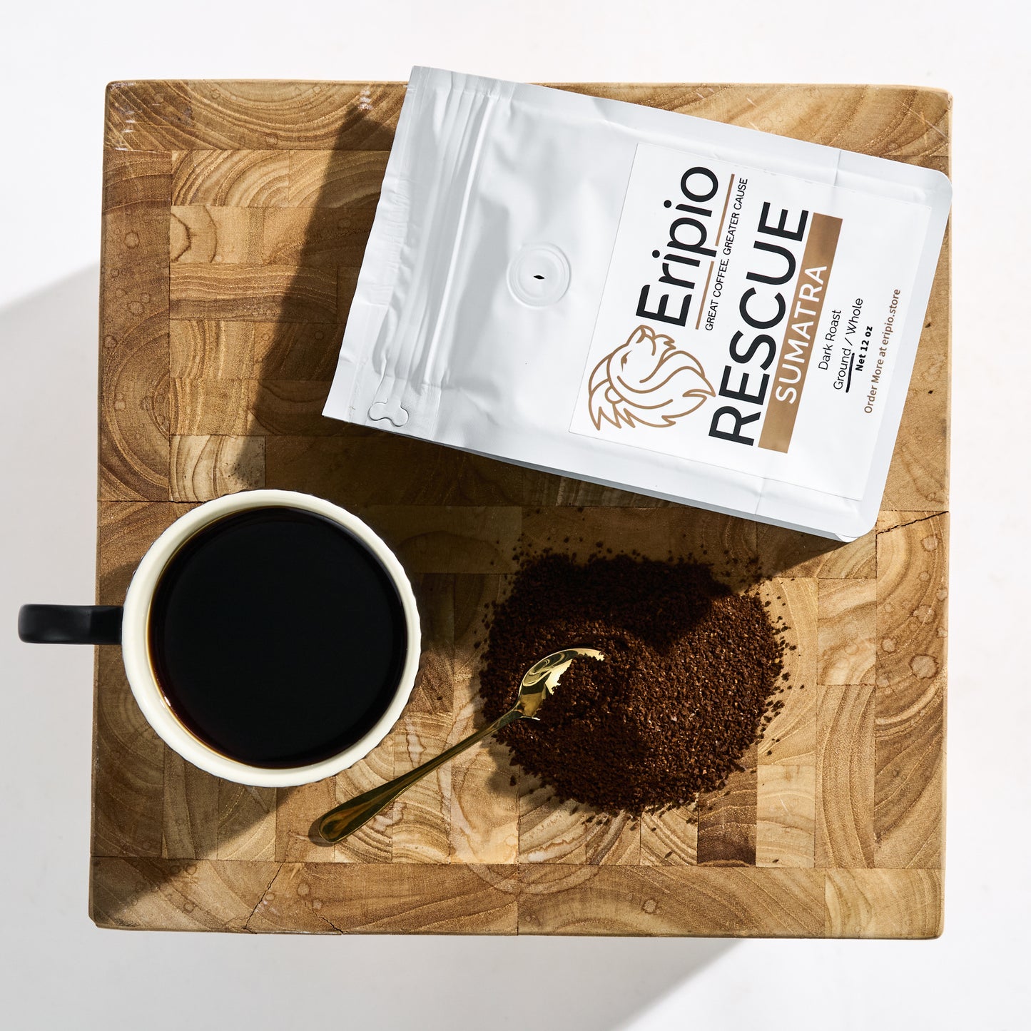 Eripio Rescue Sumatra coffee package with a cup of coffee and ground coffee on a wooden board.