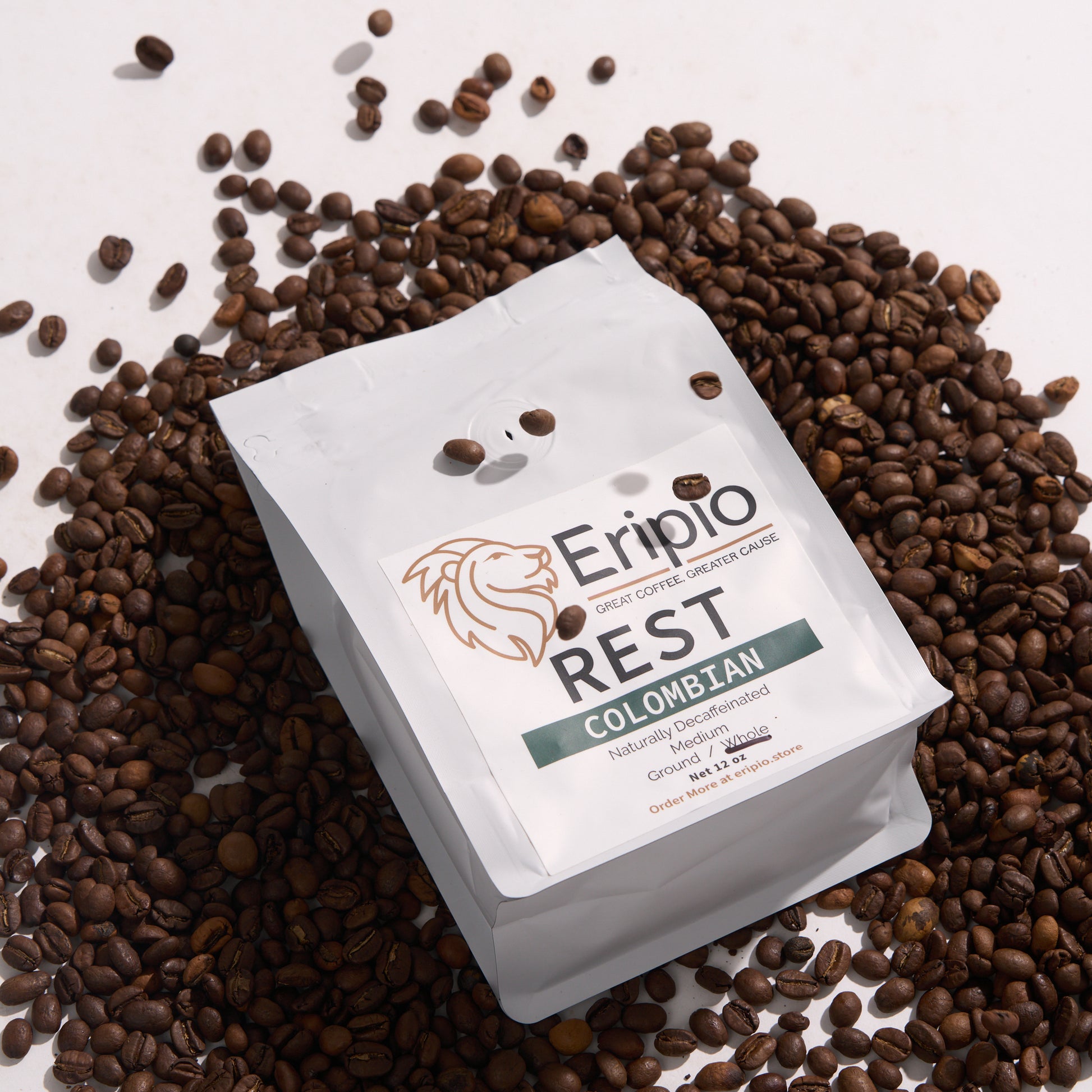 Eripio Rest Colombian decaf coffee package surrounded by coffee beans on a light background