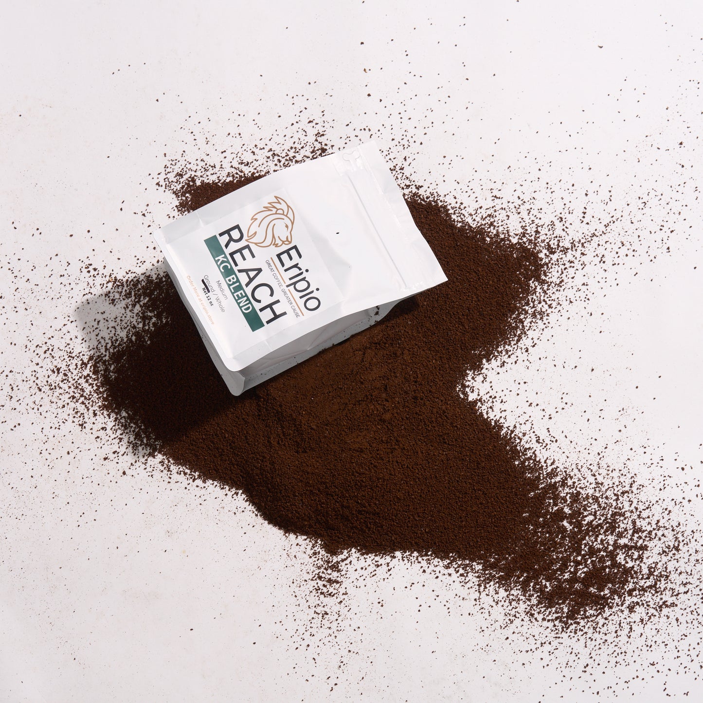 Eripio Reach coffee packaging with coffee grounds on a light background