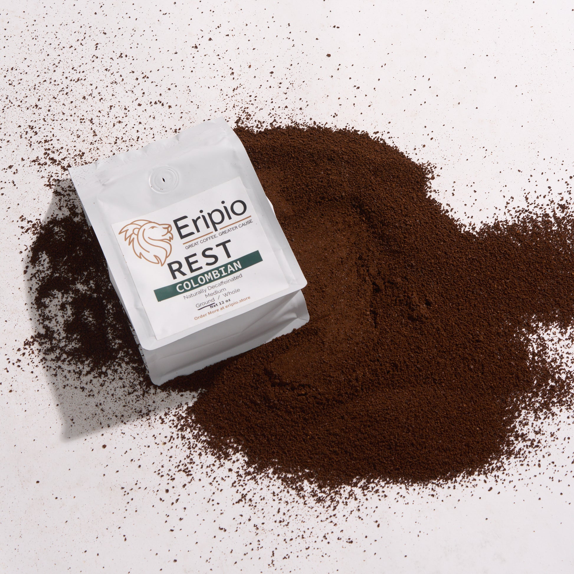 Eripio Rest Colombian decaf coffee package on a white background with coffee grounds around it